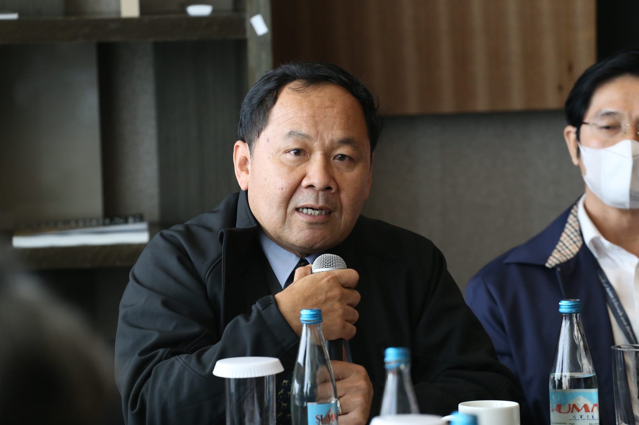 Senator Mardi Seng speaking into a microphone at a roundtable