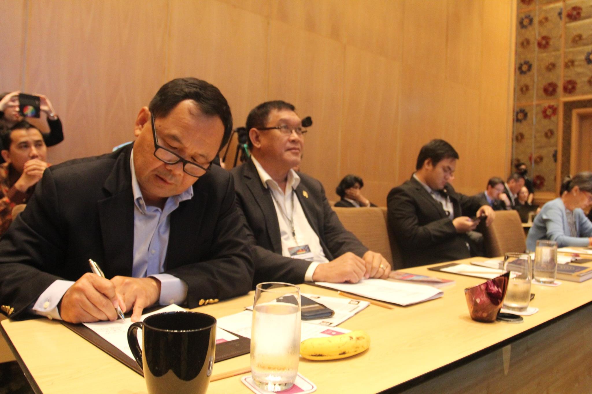 Senator Mardi Seng writing during a conference